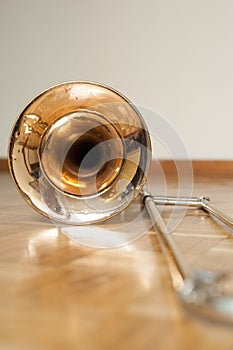 Trombone on wooden floor detail