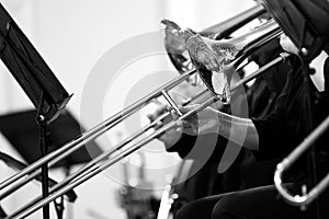 Trombones in the hands of the musicians