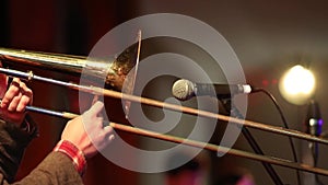 Trombonist playing live on stage