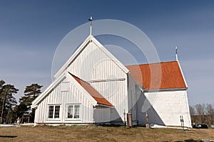 Tromoy church at Hove, Tromoy in Arendal, Norway. White church, blue sky, sunny day.