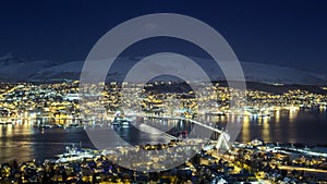 Tromso city night panorama, view from the mountains towards bridge and Arctic Cathedral