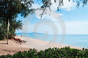 Trop[ical Phuket vibrant turqoise blue sea at Mai Khao beach wit