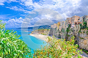 Tropea town and beach, Tyrrhenian Sea turquoise water, colorful buildings on top of high big rocks cliffs