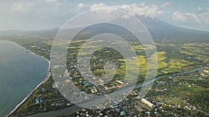 Tropic cityscape at sea bay river banks aerial. Streets with cottages and lodges with traffic road