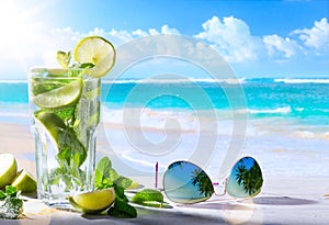 tropic summer vacation; Exotic drinks on blur tropical beach background