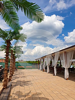 Tropical alcove in luxury hotel resort outdoor with tropical garden. Vertical, copy space