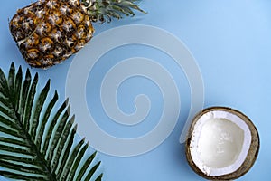 Tropical background turquoise blue with coconut and pineapple top view