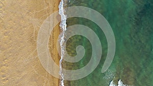 Tropical beach aerial view, Top view of waves break on tropical yellow sand beach. Sea waves seamless loop on the beautiful sand