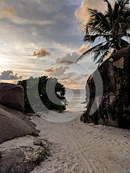 Tropical beach Anse Source d`Argent with granite boulders at sunset, La Digue Island, Seychelles