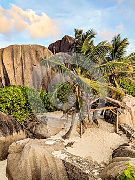 Tropical beach Anse Source d`Argent with granite boulders at sunset, La Digue Island, Seychelles