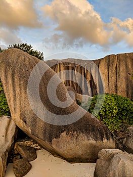 Tropical beach Anse Source d`Argent with granite boulders at sunset, La Digue Island, Seychelles