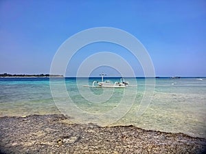 Tropical beach with azure blue water and fishing boat