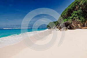 Tropical beach in Bali with blue ocean. Holidays in paradise island
