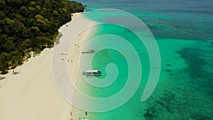 Tropical beach and blue lagoon. Puka Shell Beach, Boracay Island, Philippines, aerial view.