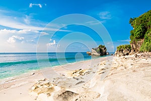Tropical beach with blue ocean, sky and sunshine in Bali