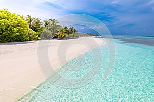Tropical beach blue sea and palm trees and white sand on the Maldives island. Summer travel destination