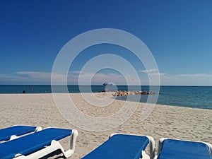 Tropical beach with boat and parasailing in the distance