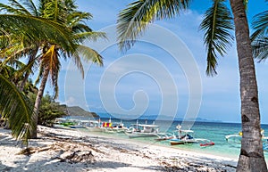 Tropical beach with boats on the Malcapuya Island, Busuanga