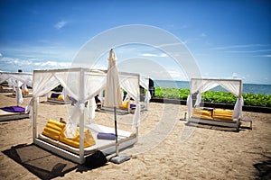 Tropical beach with canopy wooden sunbed