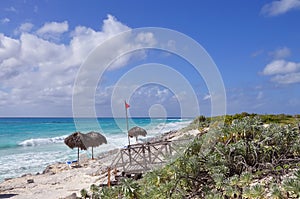 Tropical beach on the Caribbean Sea. Emerald water and tropical vegetation on the shore.