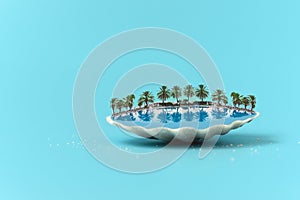 Tropical beach concept made of shall with swimming pool, deck chair and palms. Creative summer vacation concept