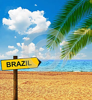 Tropical beach and direction board saying BRAZIL