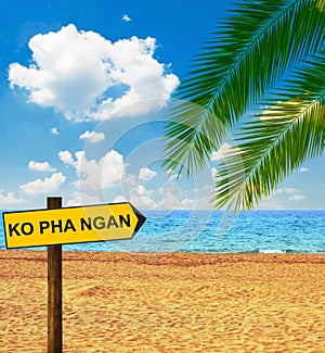 Tropical beach and direction board saying KO PHA NGAN