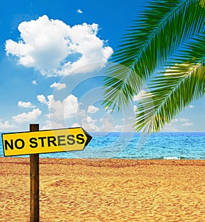 Tropical beach and direction board saying NO STRESS