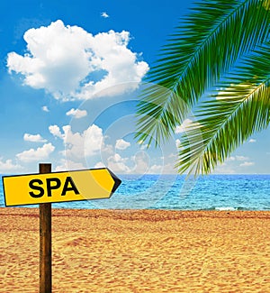 Tropical beach and direction board saying SPA