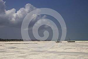 Tropical beach with fishing boats and cloudy sky,Zanzibar,Tanzania