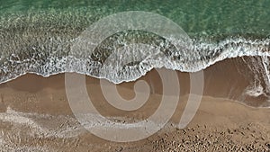 Tropical beach, foamy ocean waves washing sand. Waves hitting sand beach