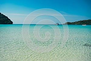 Tropical beach at Koh Kood, Thailand. turquoise sea water, ocean wave, yellow sand, green palms, sun blue sky, white clouds,