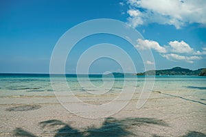 Tropical beach at Koh Kood, Thailand. turquoise sea water, ocean wave, yellow sand, green palms, sun blue sky, white clouds,