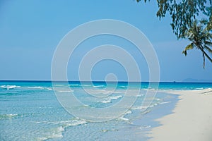 Tropical beach at Koh Kood, Thailand. turquoise sea water, ocean wave, yellow sand, green palms, sun blue sky, white clouds,