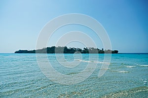 Tropical beach at Koh Kood, Thailand. turquoise sea water, ocean wave, yellow sand, green palms, sun blue sky, white clouds,