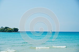 Tropical beach at Koh Kood, Thailand. turquoise sea water, ocean wave, yellow sand, green palms, sun blue sky, white clouds,