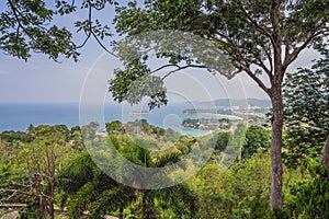 Tropical beach landscape panorama. Beautiful turquoise ocean waives with boats and sandy coastline from high view point