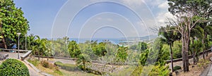 Tropical beach landscape panorama. Beautiful turquoise ocean waives with boats and sandy coastline from high view point