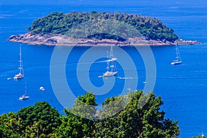Tropical beach landscape panorama. Beautiful turquoise ocean waives with boats and sandy coastline from high view point. Kata and