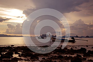 Tropical beach, long tail boats,golden sunset, gulf of Thailand,Krabi