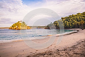 Tropical sandy beach and ocean in Bali at sunset or sunrise