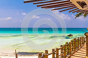 Tropical beach with palm trees and beach beds,