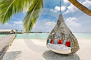 Tropical beach panorama as summer landscape with beach swing or hammock and white sand and calm sea for beach scenic banner