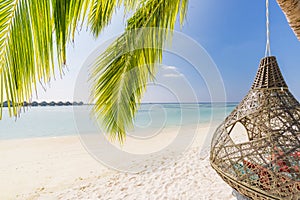 Tropical beach panorama as summer landscape with beach swing or hammock and white sand and calm sea for beach scenic banner