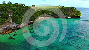 Tropical beach and rocks with turquoise ocean. Aerial view of paradise place in Bali