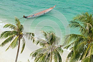 Tropical beach and rowboat photo