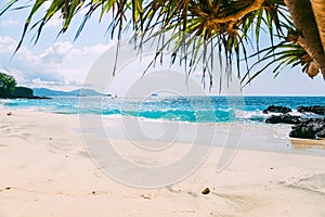 Tropical beach with sand and blue ocean wave in island