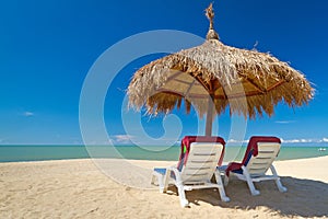 Tropical beach scenery with parasols