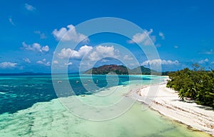 Tropical beach with sea and palm taken from drone. Beach and sea photo. Romantic beach aerial view