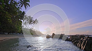 A tropical beach on the shore of the Indian Ocean. Sunrise over the Tropical island of Sri Lanka.